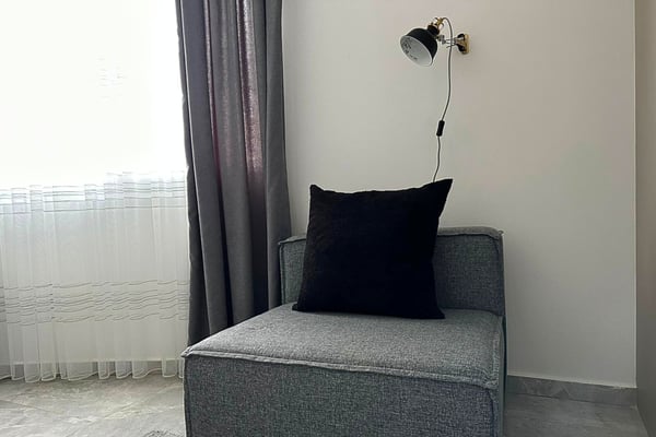 Spacious and well-lit bedroom with modern furnishings and access to a private balcony.