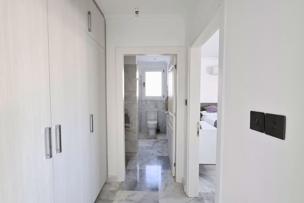 Corridor view with doors leading to bathroom or closet.