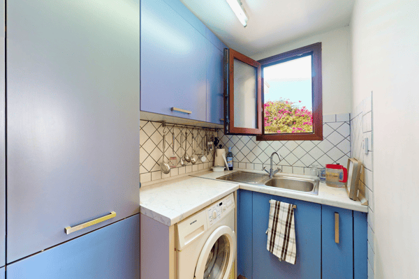 Second kitchenette with washing machine and utility sink—ideal for extended stays or staff.