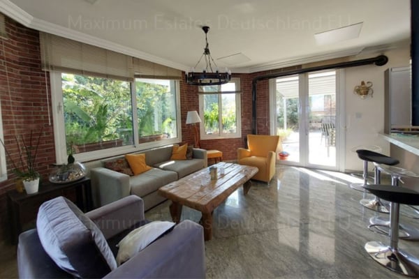 Fully equipped kitchen with ample storage, light-colored countertops, and natural lighting.