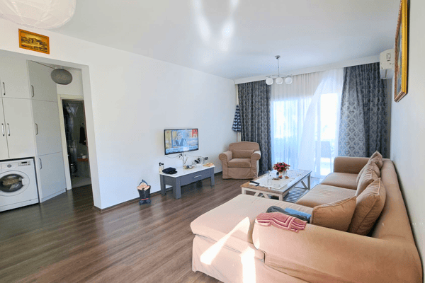Elegant living room with neutral tones, oak flooring and full-height curtains, designed for cozy evenings and relaxed ambiance.