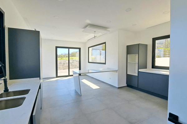 Sunlit interior with wood flooring and modern styling, ideal as a dining area.