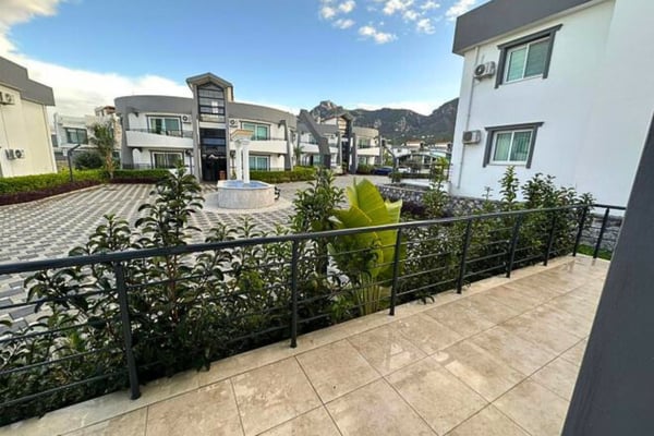 Spacious living area with a modern sofa, open floor plan, and neutral-toned interiors.