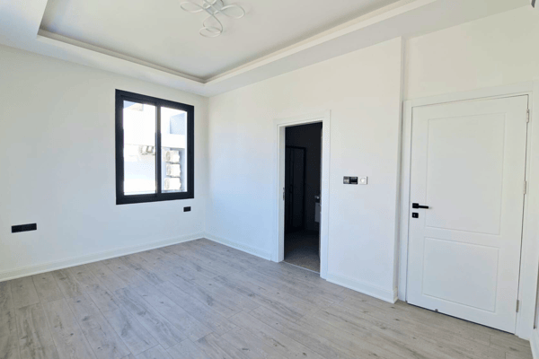 Second bedroom with open view and clean white walls.