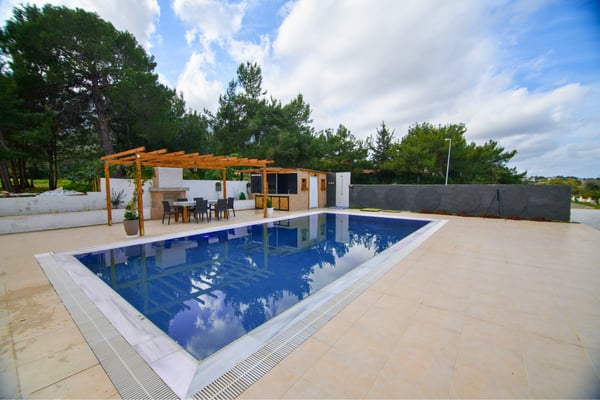 Overflow pool set in a landscaped garden offering seamless visual appeal and relaxing resort-style atmosphere.