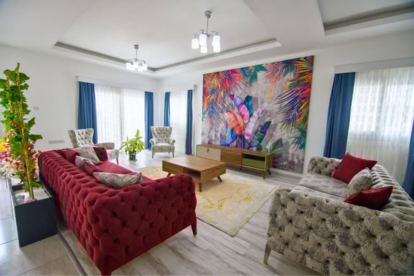 Bright living room styled with vibrant art, luxurious furnishings, and an inviting, light-filled ambiance.