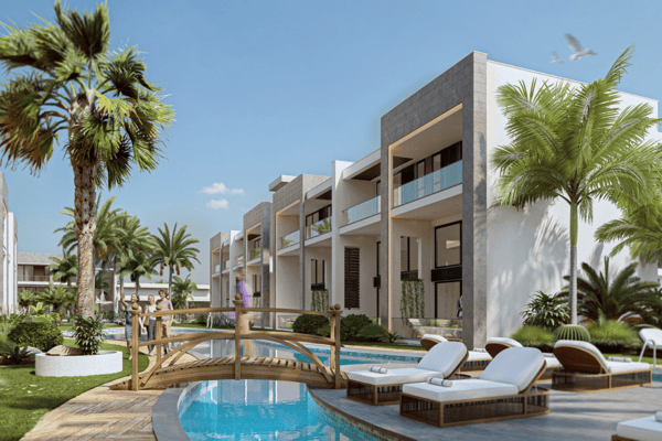 Modern Mediterranean architecture with spacious balconies surrounded by lush landscaping and a reflective pool area.