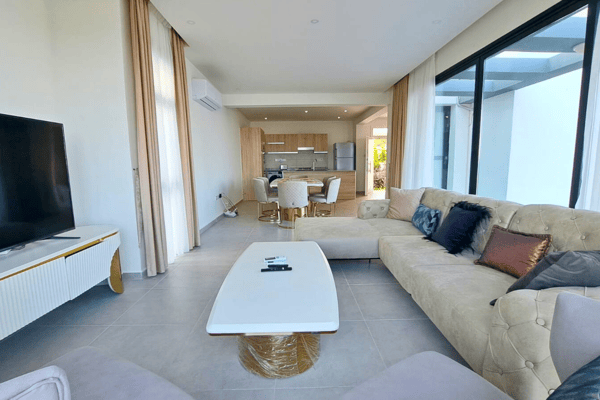 Wide lounge view featuring twin sofas and entertainment space that balances relaxation with refined design.