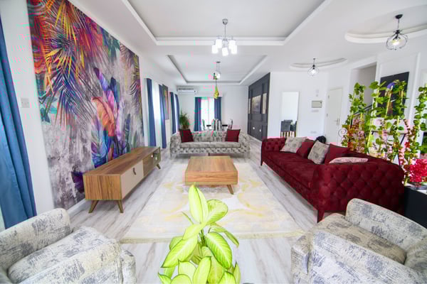 Cozy seating corner with contemporary furniture and large windows providing scenic garden views and warmth.