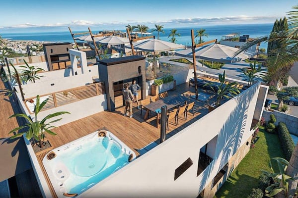 Rooftop lounge with shaded chairs and plunge pool, offering uninterrupted mountain and sea views through glass railings.
