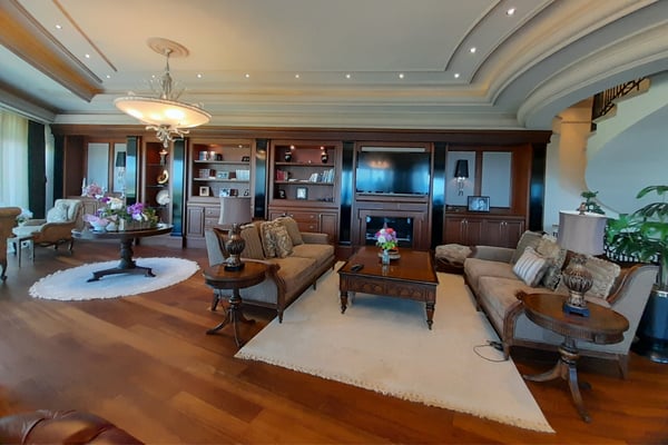 Elegant Hallway with Arches and Decorative Lighting – A grand hallway or corridor featuring stylish decorative arches or pillars, polished marble or tile floors, and recessed or cove lighting.
