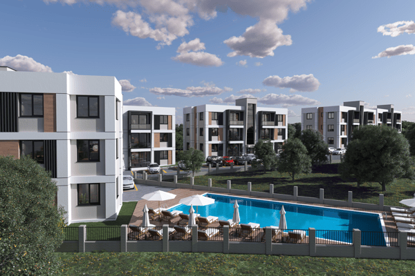 Bright daytime image of a tranquil pool area with contemporary apartments in the background, inviting a relaxed and leisurely atmosphere.