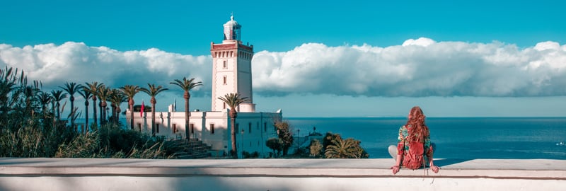 Remote worker enjoying a stunning sea-view balcony workspace in North Cyprus, capturing the perfect blend of warm climate, modern amenities, and cultural richness for digital nomads.