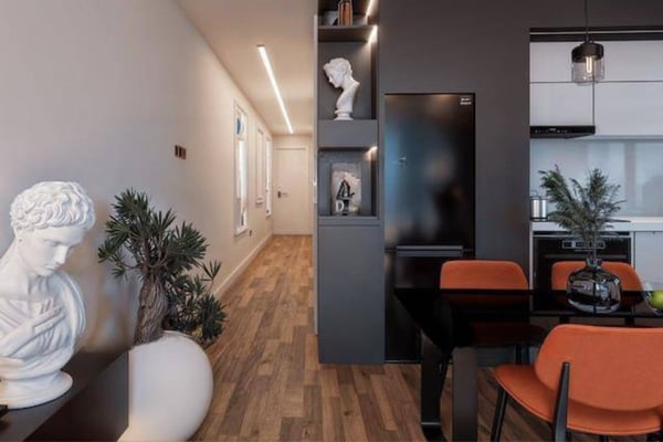 Walk-in area with built-in wardrobes and sleek, neutral doors that blend function with minimalist design.