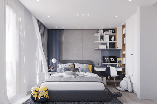 Blue-grey accent wall frames a cozy single bed and desk, offering a versatile space for guests, children or home working.