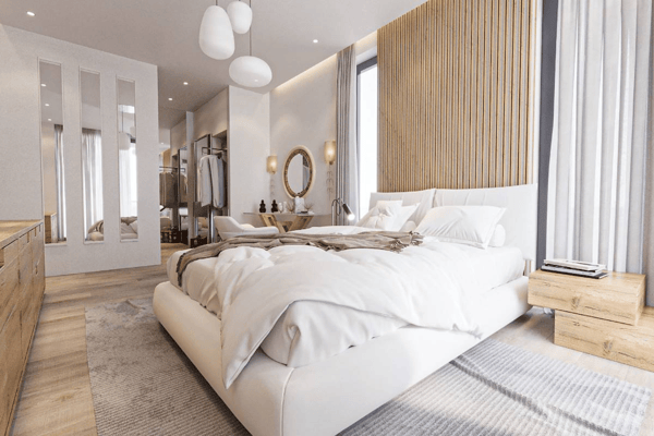 Retreat to this serene modern bedroom. A low bed rests against a warm wood accent wall, opposite sleek mirrored wardrobes, creating a peaceful ambiance.