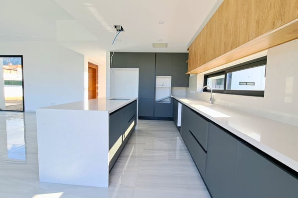 Close-up of high-end kitchen cabinets and counters with minimalist design, underlining material quality and finish.