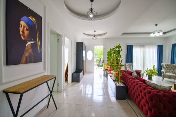 Open-concept living area with natural light, modern decor, and artistic accents creating a refined atmosphere.