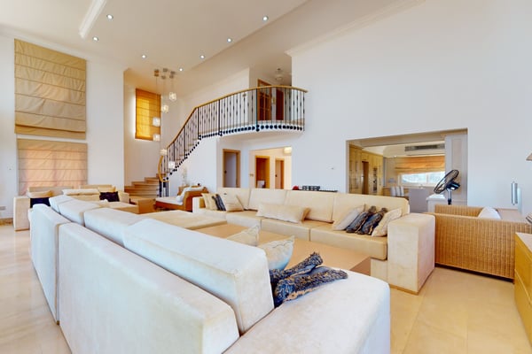 An open-plan sitting area with comfortable lounge chairs, stylish wall art, and a bright, airy ambiance.