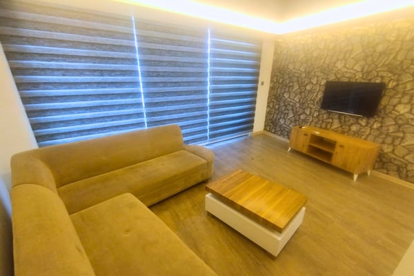 Stylish living room view featuring sleek furnishings and soft lighting, creating a space where elegance meets everyday comfort.