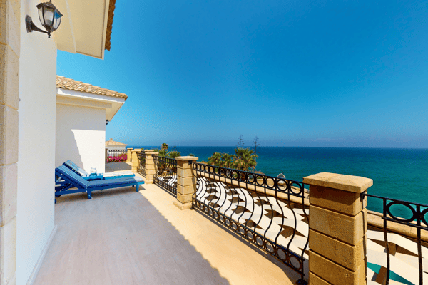 Classic balustraded balcony offering a cozy corner to enjoy the ocean horizon.