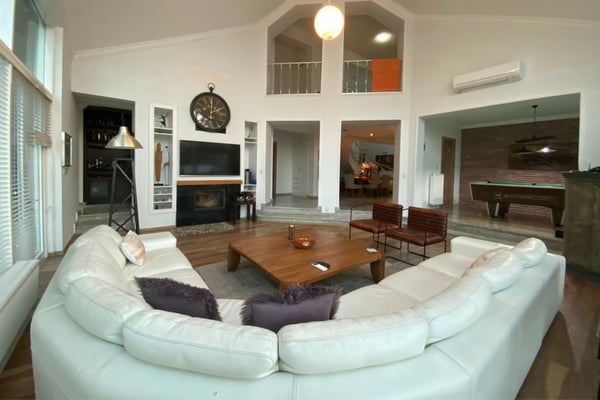 Private cinema room with plush recliners, a large screen, and dimmable lighting.