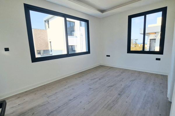 Bedroom with large picture window and light ceramic floors.