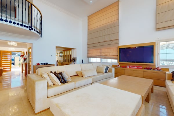 Spacious walk-in closet with custom-built wooden storage units, stylish lighting, and organized shelves for clothing and accessories.