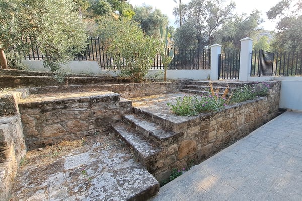 Stone Walkway Leading to a Scenic View – A paved stone path leading to an open landscape.