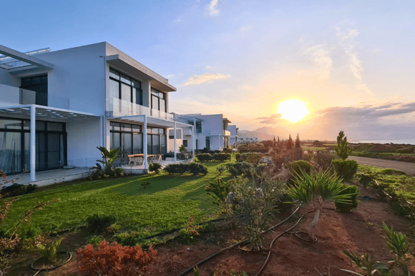Golden hour bathes the villa complex in warm light, highlighting scenic beauty and a peaceful Mediterranean lifestyle.