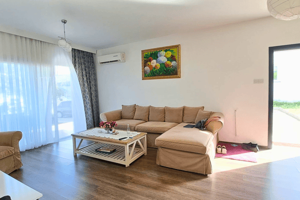 Living room with sliding doors to the garden and pool deck, blending indoor comfort with seamless outdoor connection.