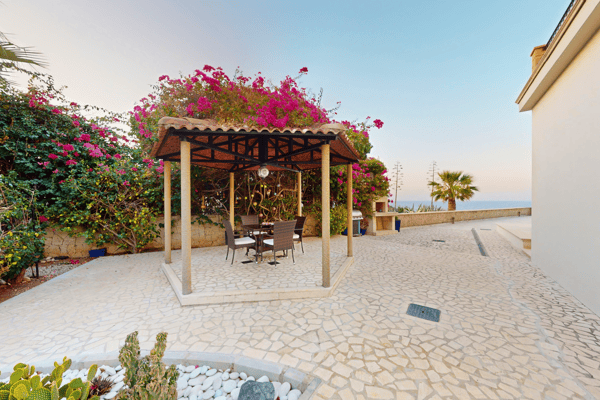 Garden pergola space covered in blooming bougainvillea—romantic and shaded for outdoor dining.
