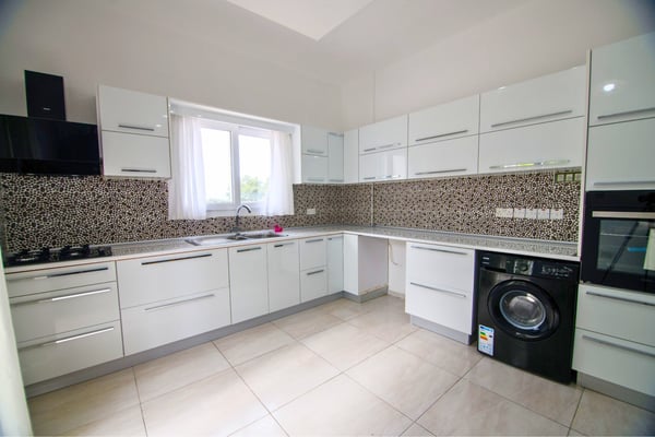 Contemporary kitchen with open shelving and natural light designed for function and modern elegance.