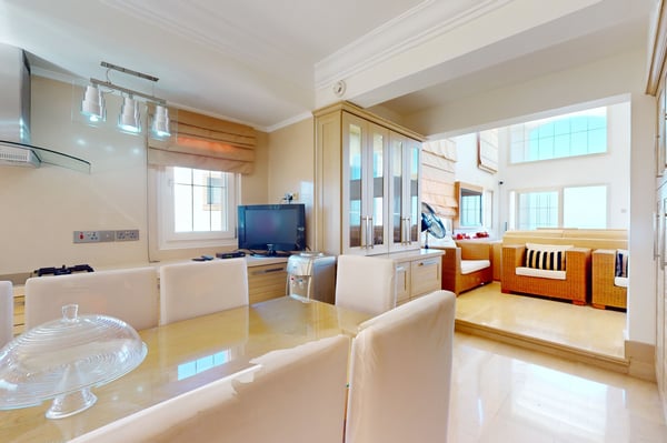 Spacious laundry room with neatly arranged washing and drying machines, ample storage, and modern finishes.