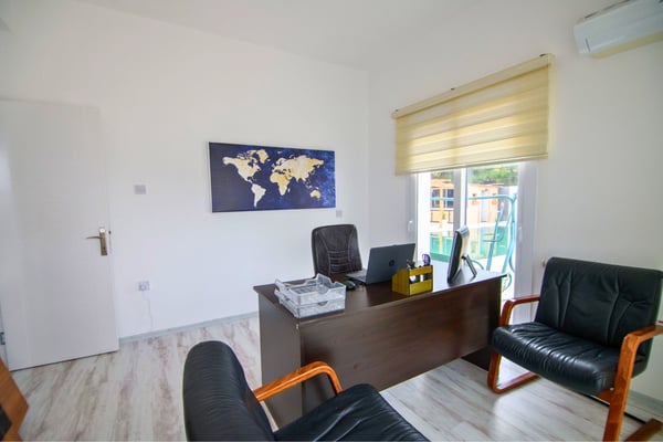 Multifunctional room styled as a home office with practical layout and soft lighting for focused comfort.