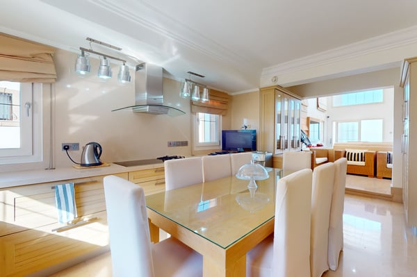 Private home gym with various exercise machines, mirrored walls, and large windows allowing in natural light for an enjoyable workout experience.