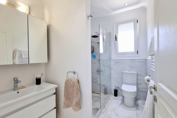 Another bathroom angle with large mirror and countertop sink.