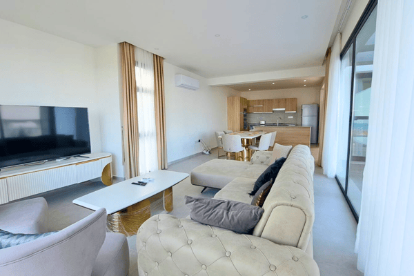 Comfortable lounge with sectional sofa and large windows that flood the room with soft, natural daylight.