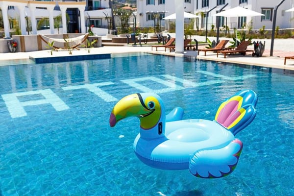Poolside relaxation with turquoise sun loungers and umbrellas, creating a holiday-like ambiance.