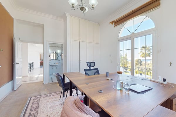 A bright and airy bedroom with a cozy wooden bedframe, offering the perfect place to wake up to the Cyprus sunshine.
