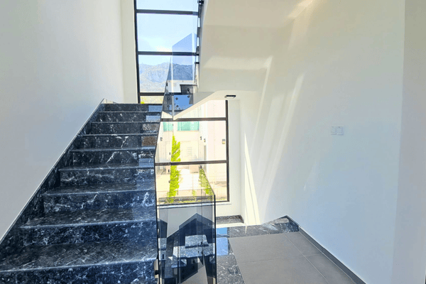 Staircase view revealing vertical window and airy architectural layout.