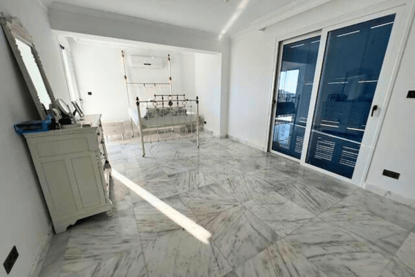 Utility room or bathroom entryway with light reflecting off marble tiles.