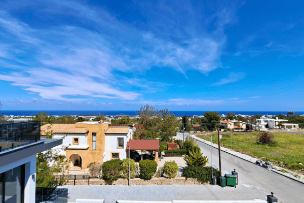 Neighborhood view from upper balcony, capturing surrounding homes and terrain.