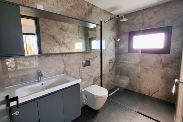 Refined bathroom with sleek vanity, modern mirror, and high-end fixtures that reflect quality and attention to detail.