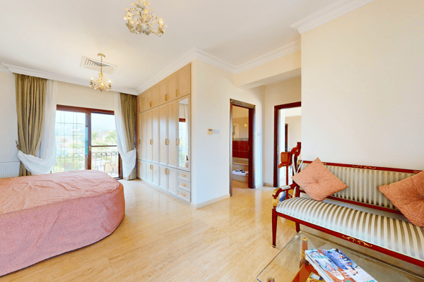 Bedroom suite with sitting area and access to terrace, ideal for unwinding privately.