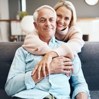 Illustration of British retirees David and his wife enjoying their new life in North Cyprus, surrounded by scenic landscapes and a vibrant expat community. The visual highlights their ability to live comfortably on their pensions without worrying about the rising cost of living or healthcare expenses.