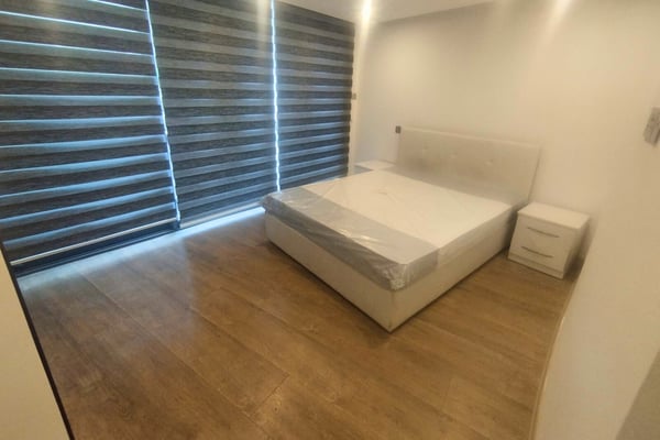 Thoughtfully styled bedroom corner with built-in storage and cozy seating, offering a personal nook for peace and quiet.