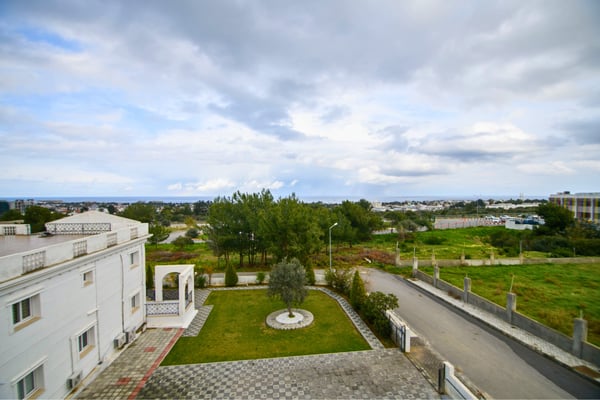 Distant city skyline and surrounding nature as seen from the elevated position of the villa’s upper terrace.