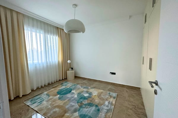 Additional view of the second bedroom featuring neutral decor and light textures for a bright, calming ambiance.
