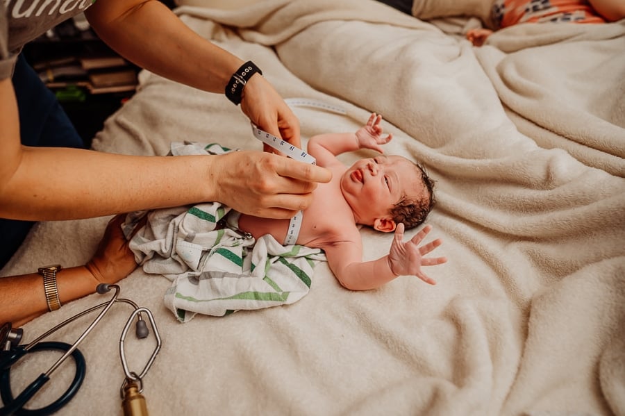 Woman giving birth at home